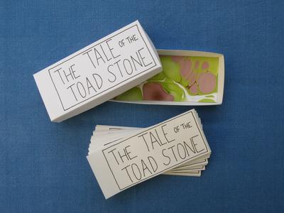 Hand made Tale of the Toad Stone comic set as cards in a box on a blue cloth background