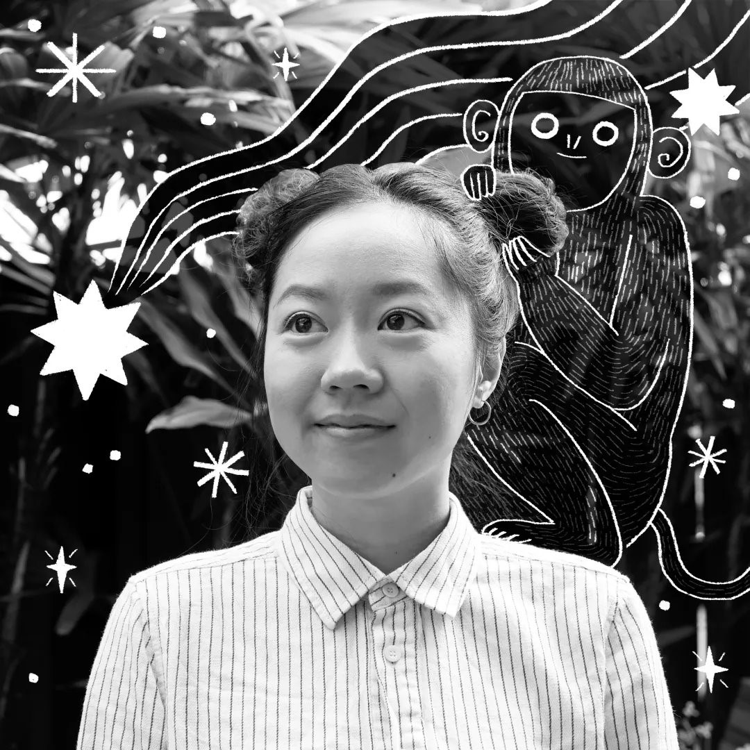 A person smiling with a monkey drawn on her head